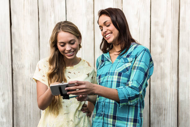 istock Two friends looking at mobile phone 675782764