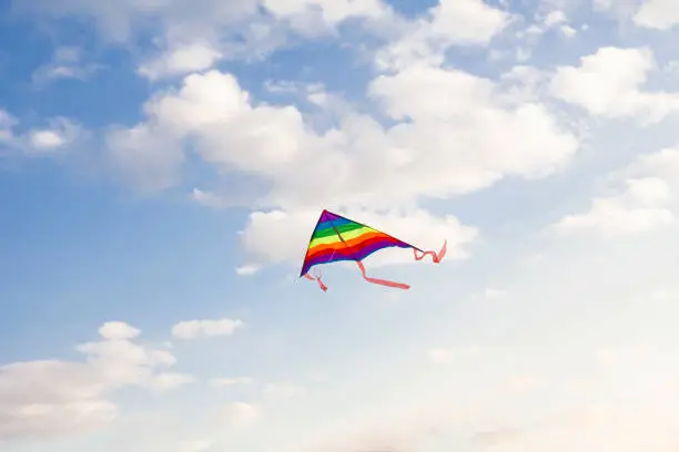 Colorful kite flying in cloudy sky