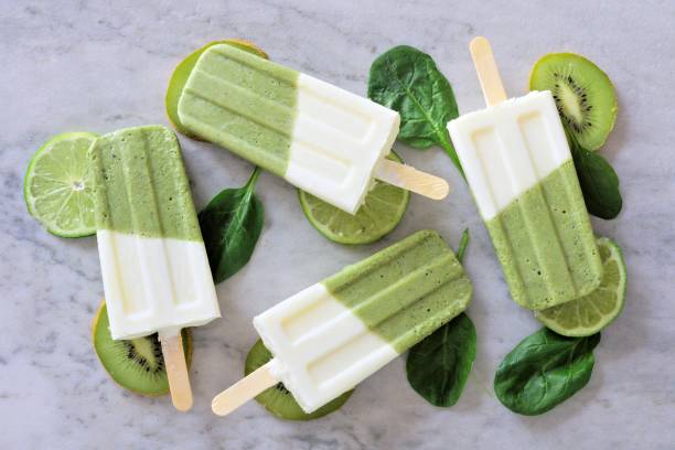 istock Healthy green smoothie popsicles over a marble background 675793626
