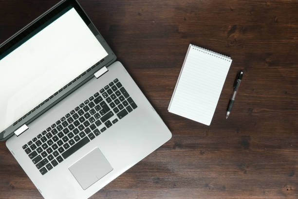 istock laptop on desk with coffee and notepad top view 675793964