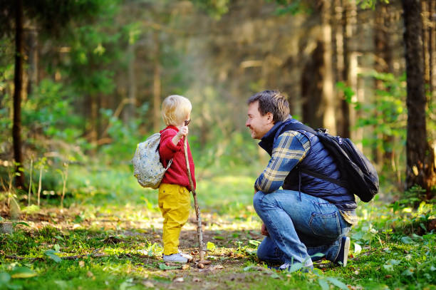 istock Father and his son walking during the hiking activities in forest 675796964