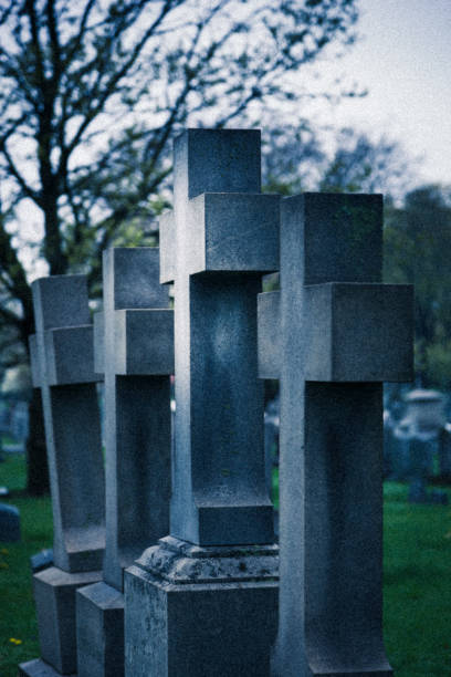 istock Tall Cross Tombstones in a Row in Cemetery 675801882
