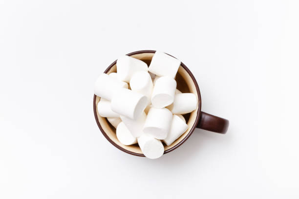 istock marshmallow in cup, top view flat lay on white background 675810674