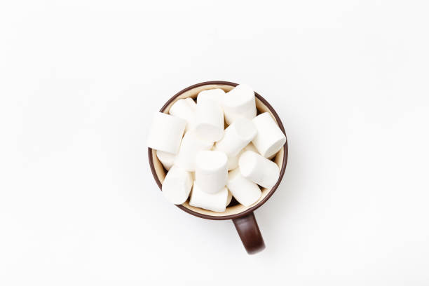 istock marshmallow in cup, top view flat lay on white background 675810780