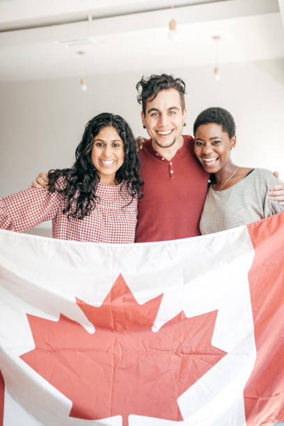 istock Students holding Canadian flag 675811180