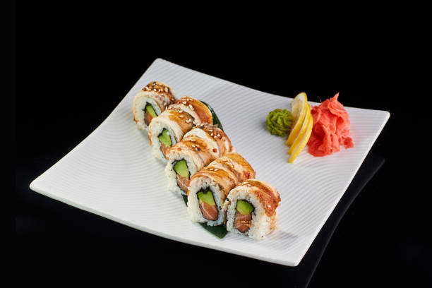 istock Sushi Roll with baked salmon, avocado and sesame 675814088