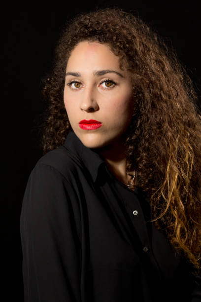 istock Curly Young Serious Lady Portrait 675814852