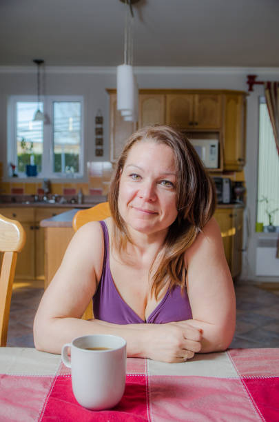 istock Woman relaxing at dining table with a coffee 675815252