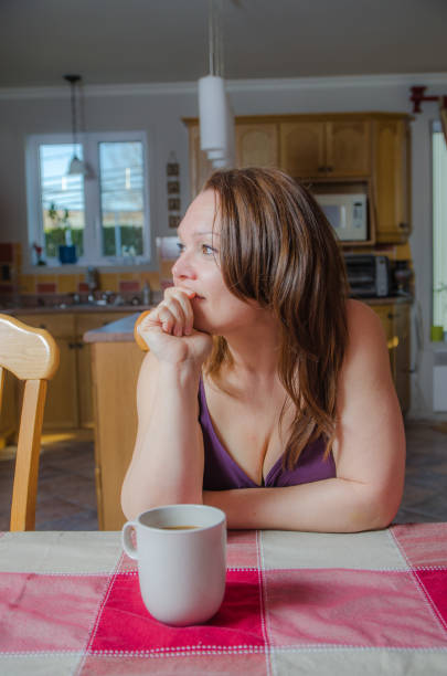 istock Woman relaxing at dining table with a coffee 675815294