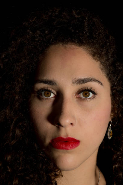istock Curly Young Lady Frontal Portrait with Strong Shadows 675815480