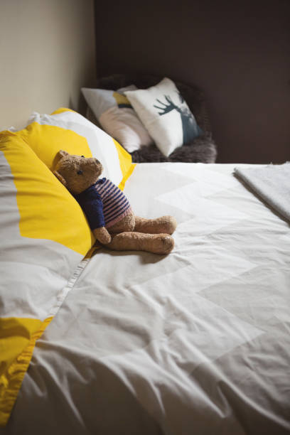 istock Cute toy teddy bear on a bed 675815766