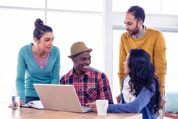 istock Happy business people discussing at creative office 675817198