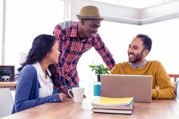 istock Happy business people discussing at creative office 675817252