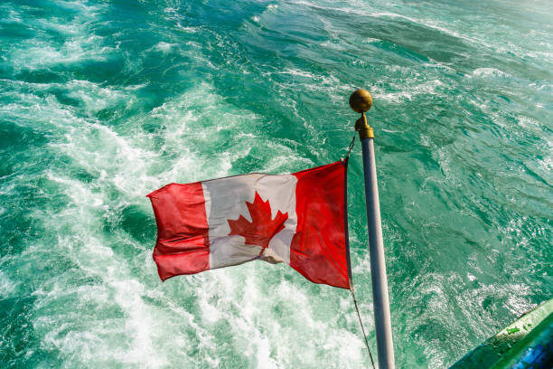 istock Canadian flag on a boat at Niagara Falls 675817892