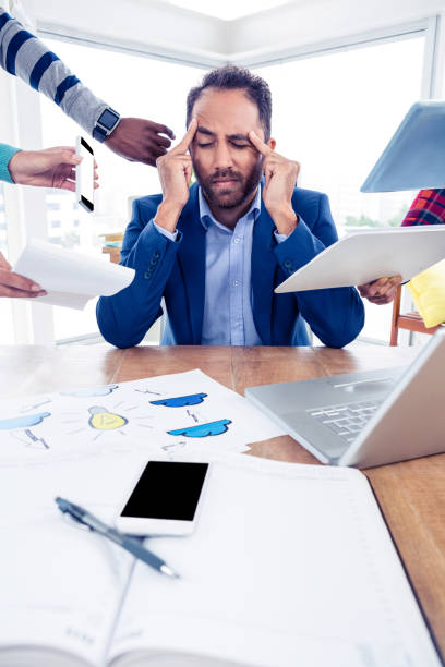 istock Stressful businessman with head in hands at creative office 675818846
