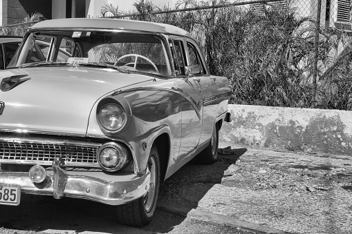 Havana, Cuba - February 2,2017: Old american car on the road Old Havana, Cuba.Thousands of these cars are still in use in Cuba and they have become an iconic view and a worldwide known attraction