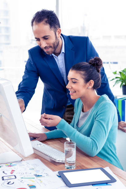 istock Young businessman and businesswoman working on computer 675819952