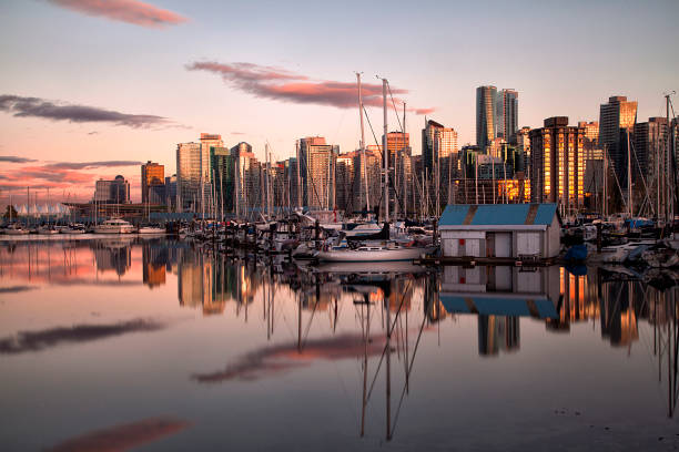 Vancouver skyline sunset reflection, Canada Vancouver skyline sunset reflection in Stanley park on a sunny Spring afternoon. shadow british columbia landscape cloudscape stock pictures, royalty-free photos & images