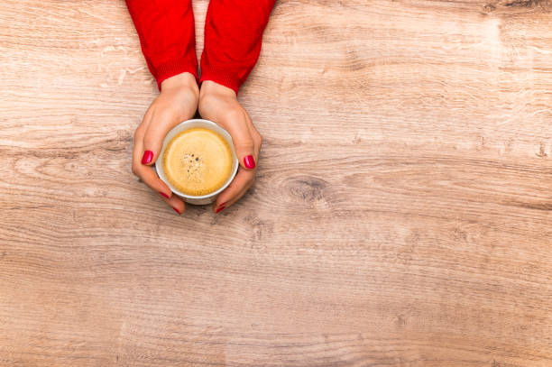 istock Female hands holding a cup of hot coffee 675822062