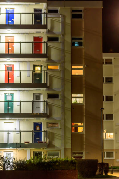 istock Appartment building with multi color doors at night 675823946