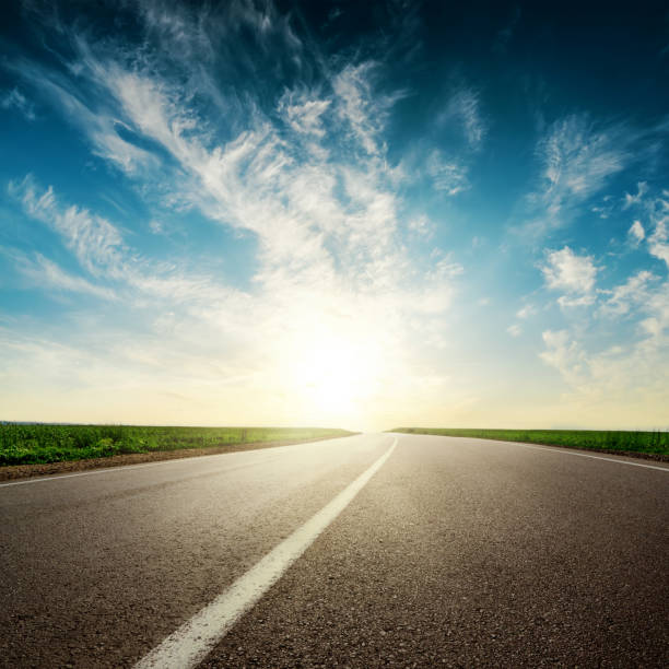 istock sunset in clouds over asphalt road 675825336