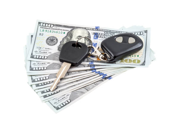 Car's keys on the money. Isolated on white. Car's keys on the money. Isolated on white. cash for cars stock pictures, royalty-free photos & images