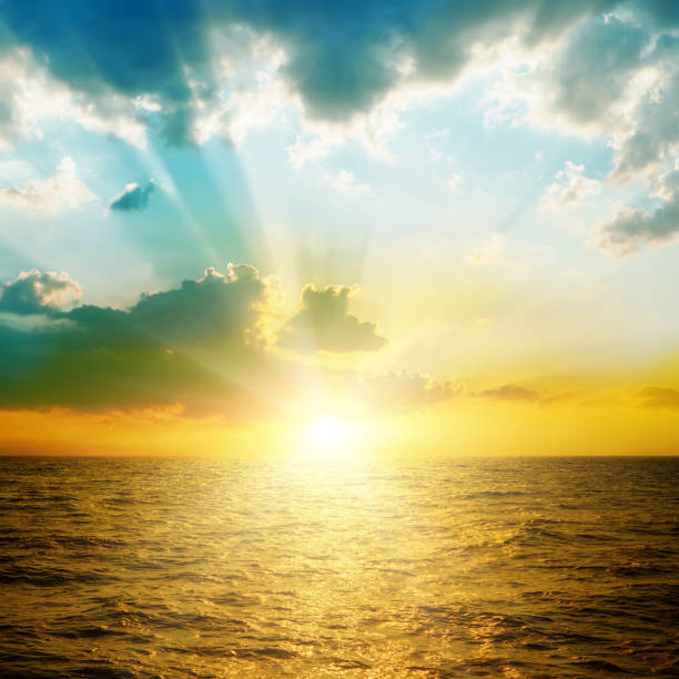 istock bright sunset in clouds over orange sea 675827556