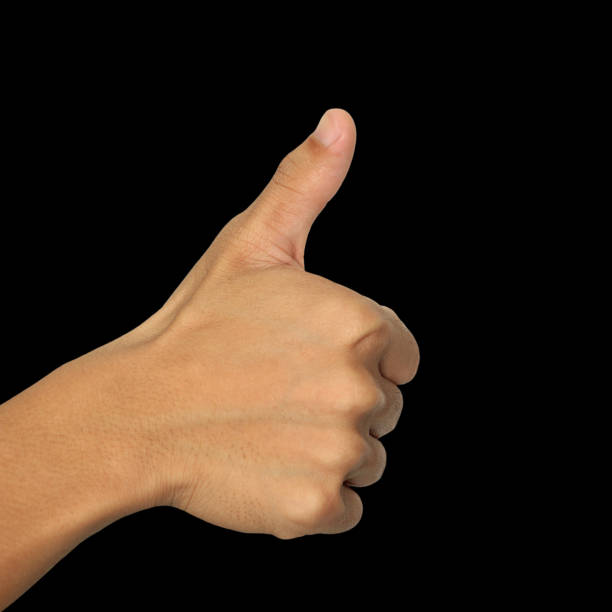 istock men hand make thumbs up isolated over black background. 675879308
