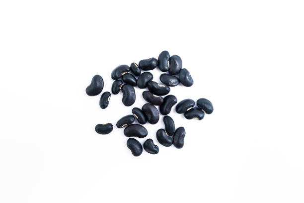 istock Black beans in the wood box isolated on white background. 675892288