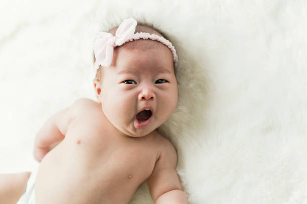A close up of a vintage baby doll close up and lit by a ring light.