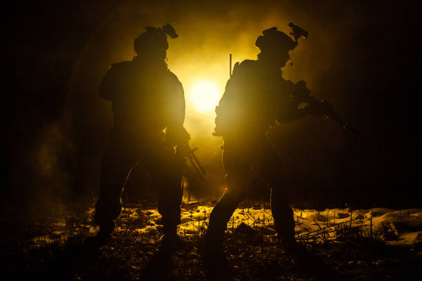 A striking silhouette portrait of a person equipped with military tactical attire and high-tech night vision equipment, standing in the shadowed foreground, exuding intensity and advanced technology themes.