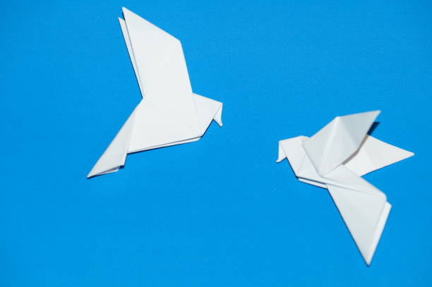 istock Origami pigeons on a blue background. 675902968