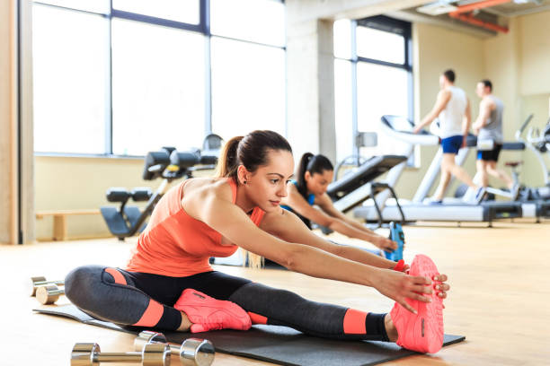 istock Young woman stretching in gym 675903494
