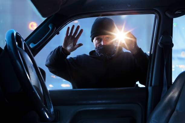 мужчина преступник врезаться в машин�у, чтобы украсть - car prowler стоковые фото и изображения