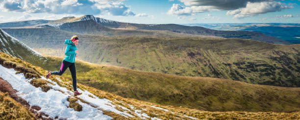 istock Young woman training trail running along mountain ridge wilderness panorama 675908542