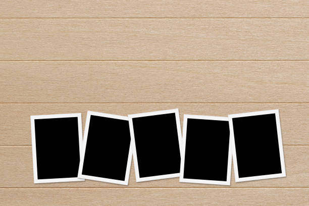 istock Blank photos on Wooden Table Background 675910054