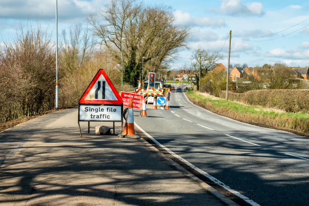 day view road narrows uk roadworks sign - road uk sign road sign photos et images de collection