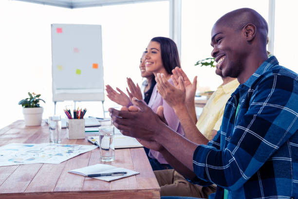 istock Cheerful businessman applauding in conference room 675913284