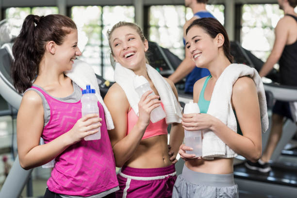 istock Athletic smiling women posing with bottle of water 675913438