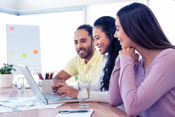 istock Happy business team working over laptop 675913642
