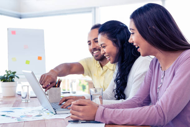 istock Cherrful business team working over laptop 675913682