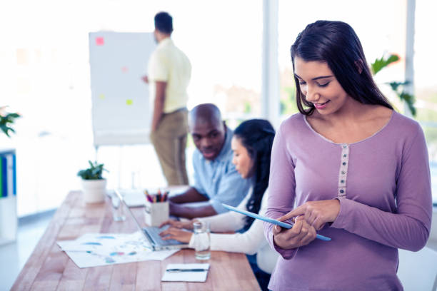 istock Young businesswoman using tablet PC in conference room 675913900