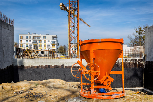 Red cement mixer  on new complex of apartment buildings under construction, Szczecin, Poland