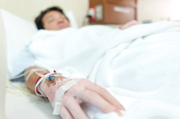 istock selective focus at hand&saline drip - Patient admit in hospital with iv saline 675920206