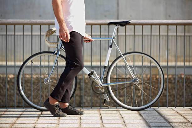 istock Low section of man with bicycle by railing 675920544