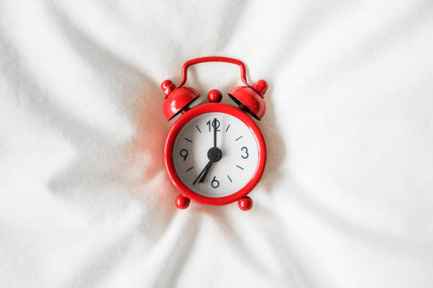 istock Clock on the bed in the morning 675926360