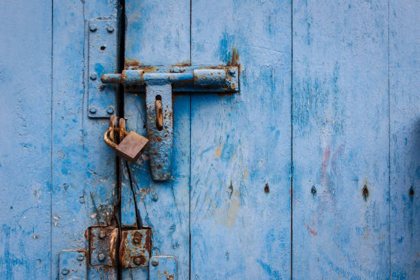 istock The padlock locking the old blue wooden door 675926718