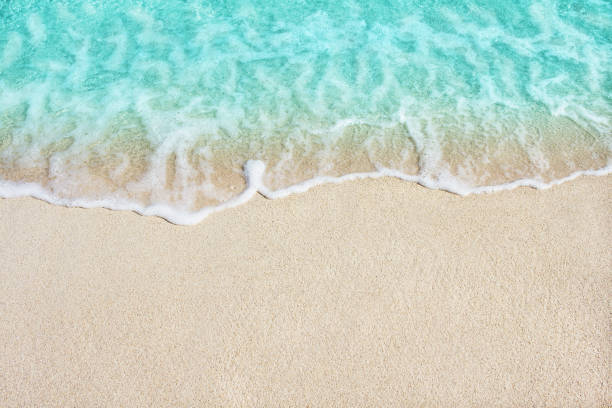 istock Soft wave of blue ocean on sandy beach 675928624