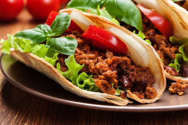 istock Mexican tacos with minced meat, beans and spices 675930782