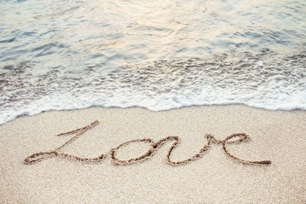 istock Love handwrittten on the tropical beach 675930886